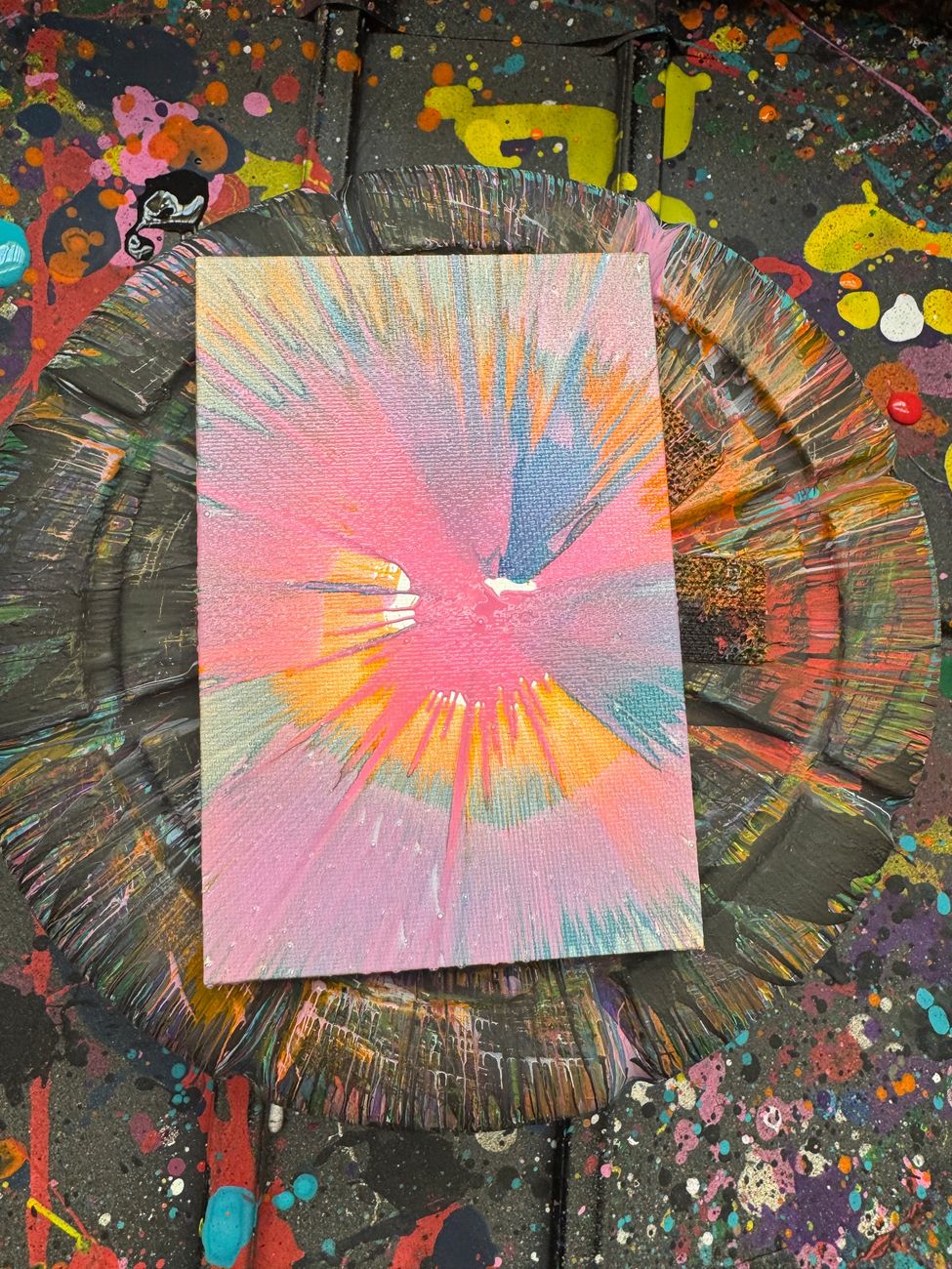 A colorful pastel spin-art canvas